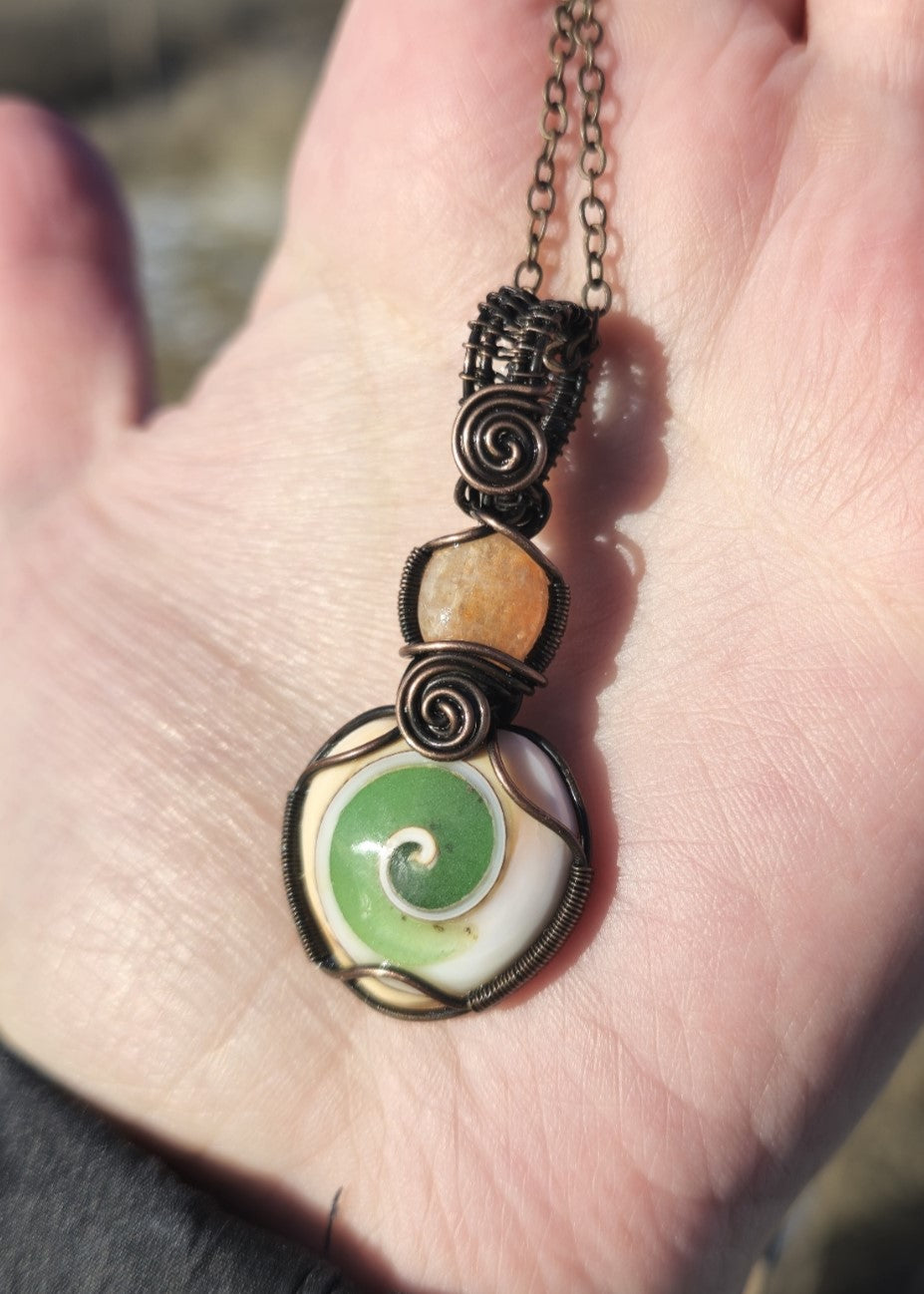 UV Reactive Glow in the Dark Shiva Shell Pendant With Sunstone Wire Wrapped in Antiqued Copper